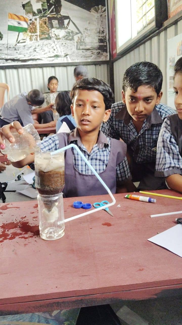 Children building science models in classroom